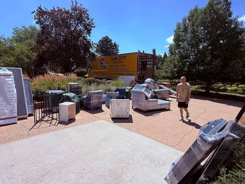 Furniture staged and wrapped on a patio before loading