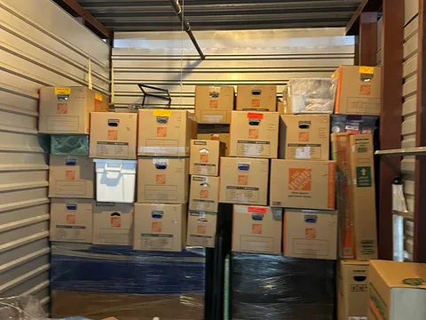 Moving boxes stacked and organized inside a storage space