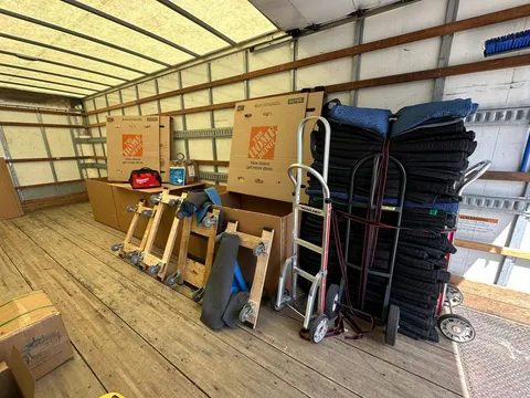 Moving blankets, dollies, and equipment organized inside the truck