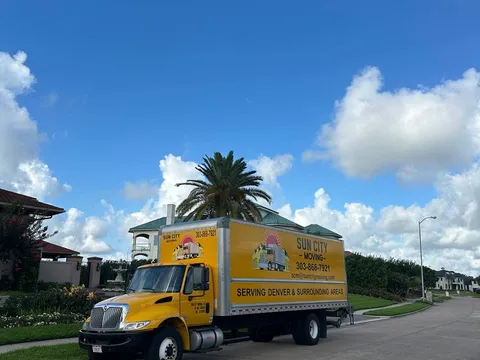 A Sun City Moving truck parked at a residential community