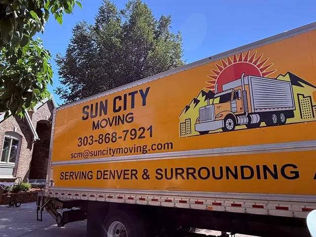 A Sun City Moving truck parked in a residential driveway