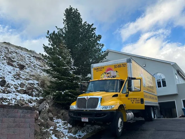 A Sun City Moving truck parked at a residential driveway ready for a full-service move