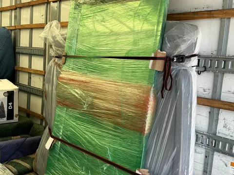 A large piece of furniture wrapped in protective padding inside the moving truck